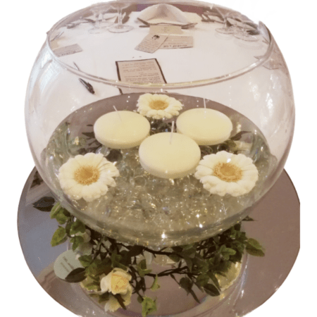 Fishbowl with Fresh Floating Gerberas and Candles on Mirror Plate